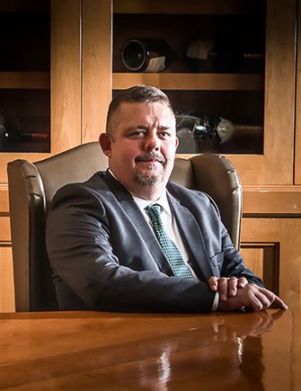 Timothy R Johnson sitting at his desk